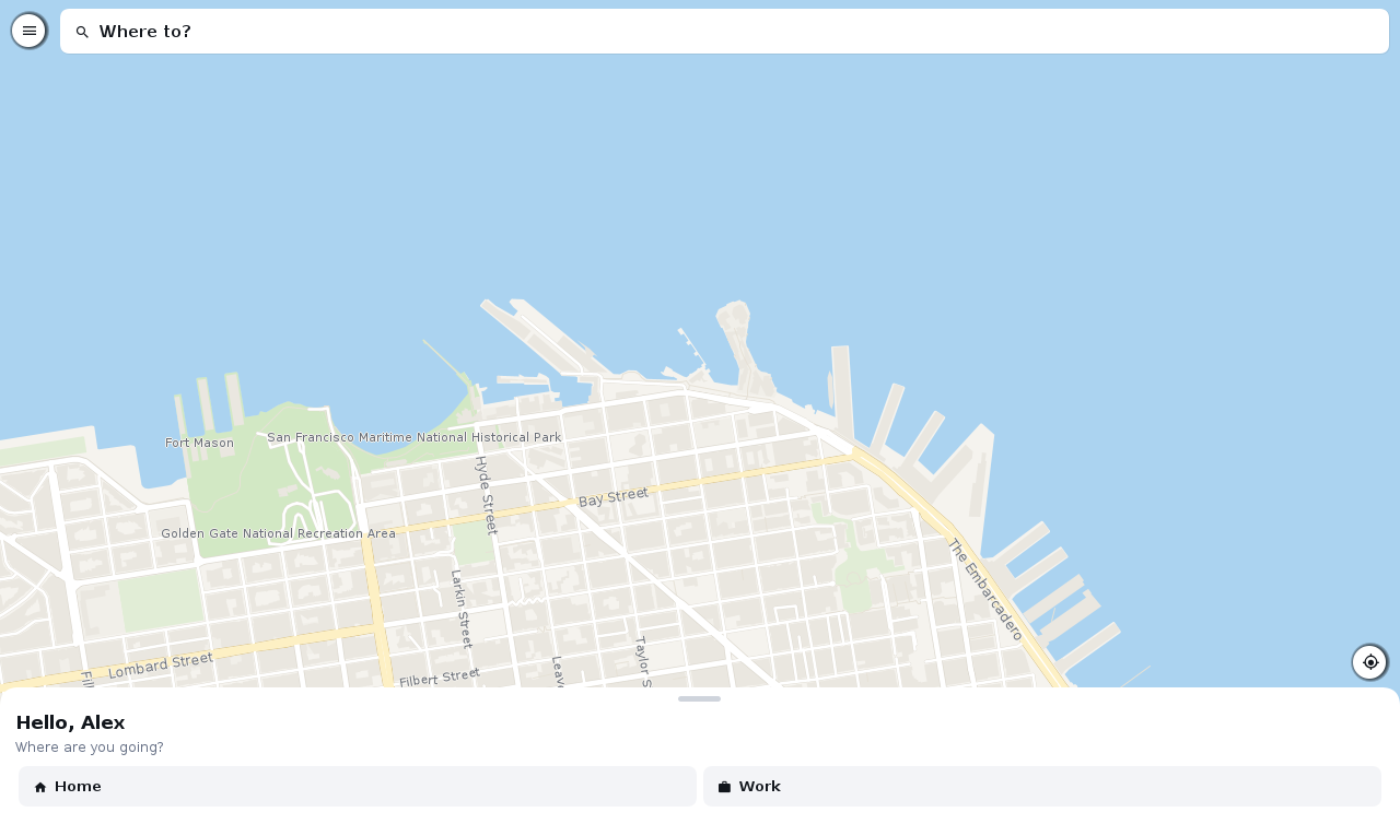 The rider home screen filling a desktop window with a wide map and the search card across the top